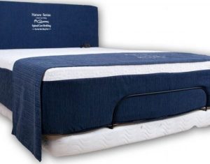 A bed with blue sheets and white sheets